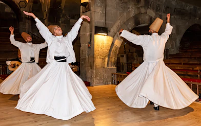 Whirling dervishes performing in a traditional ceremony in Cappadocia, Turkey.