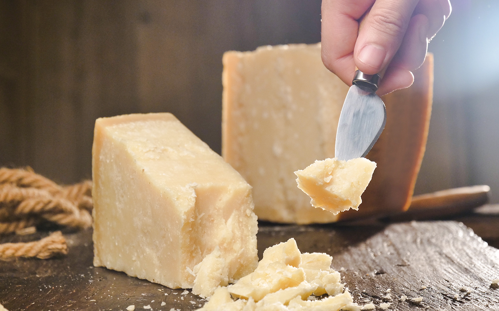 Chef slicing cheese at Cheese Museum in Paris.