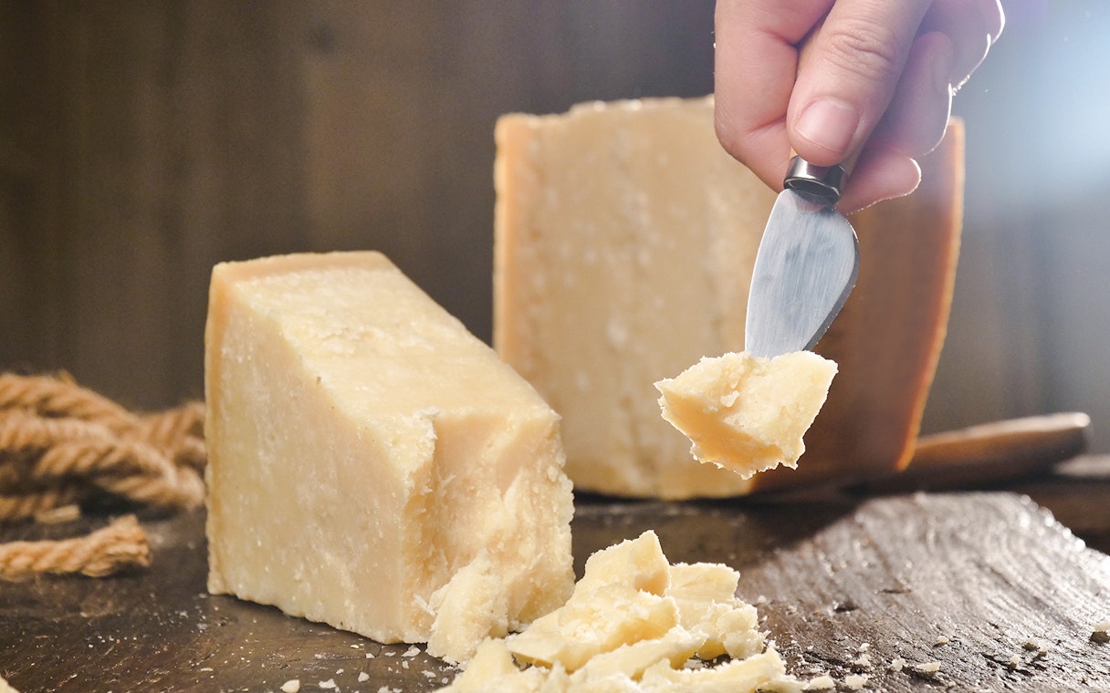 Chef slicing cheese at Cheese Museum in Paris.