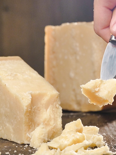 Chef slicing cheese at Cheese Museum in Paris.