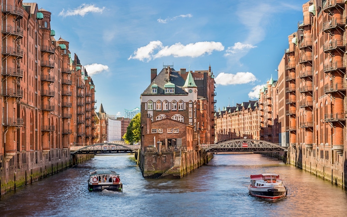 Historic Speicherstadt district with canal and boats in Hamburg, Germany.