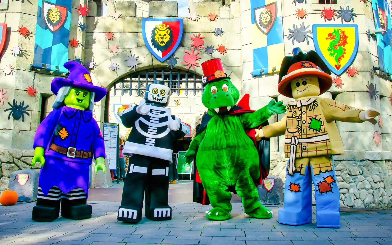 Lego characters in Halloween costumes at Legoland Billund entrance.