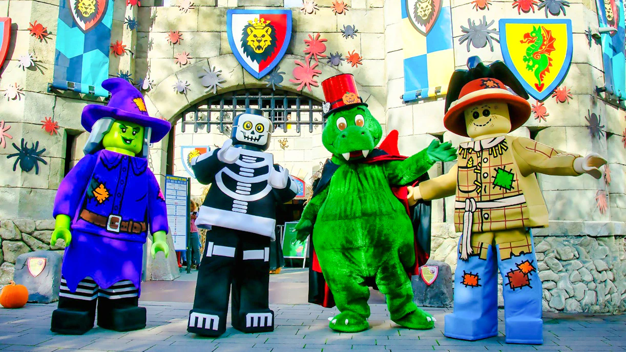 Lego characters in Halloween costumes at Legoland Billund entrance.