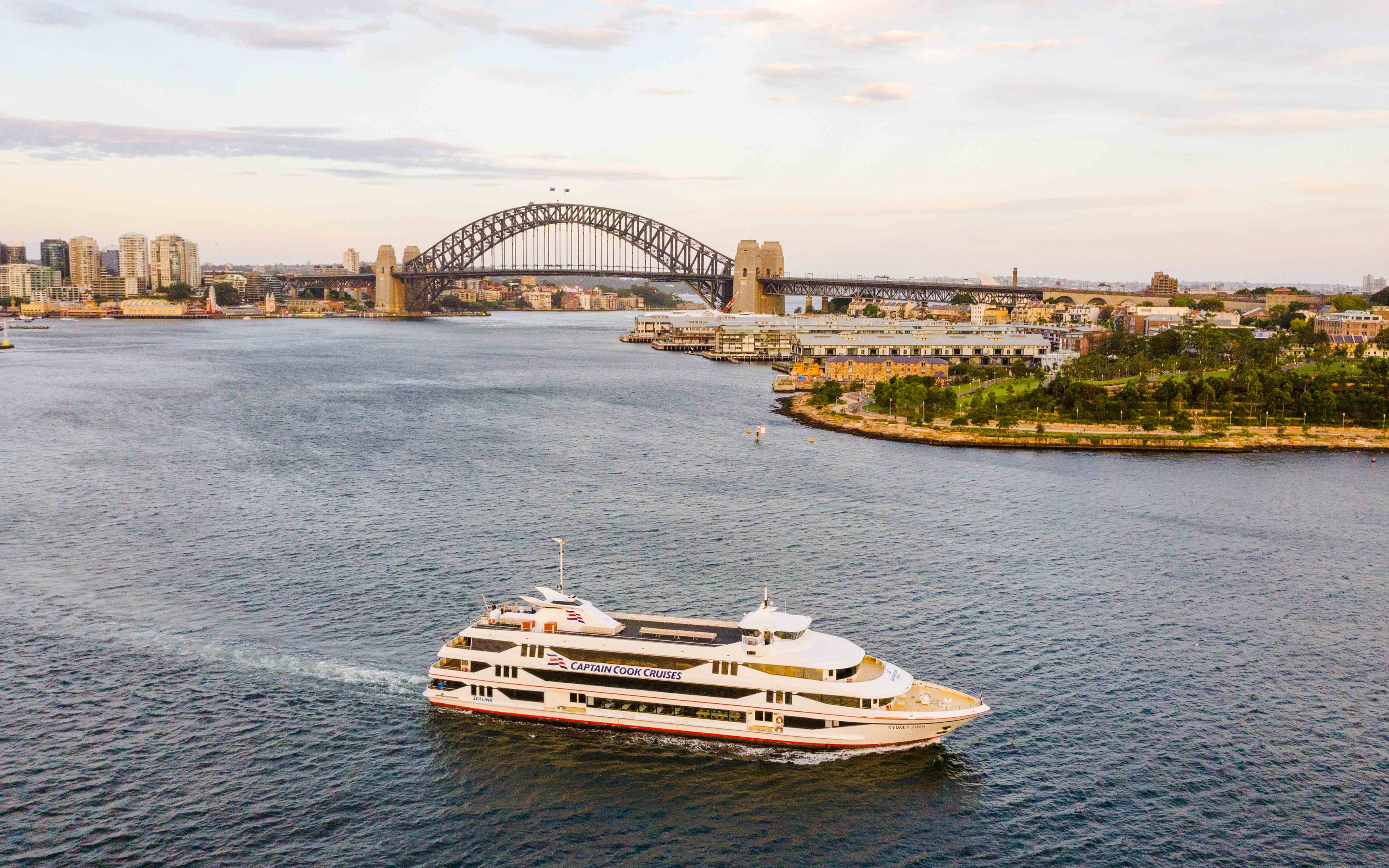 Cruise ship on Sydney Harbour with Sydney Harbour Bridge in the background.