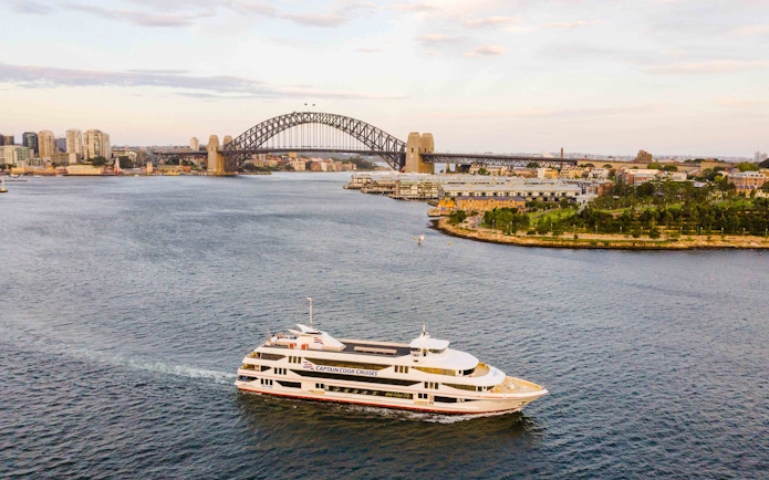 Cruise ship on Sydney Harbour with Sydney Harbour Bridge in the background.