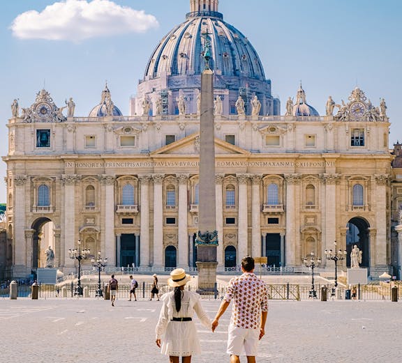 Couple walking towards St. Peter's Basilica in Vatican City.