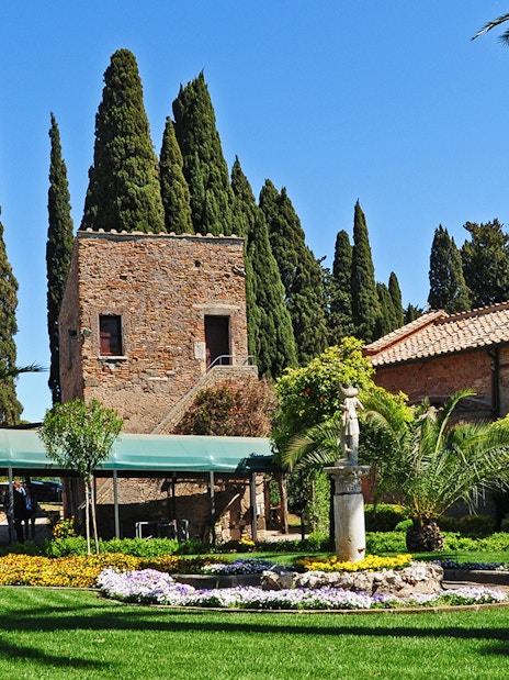 Entrance to Catacombs of St Callixtus with garden and stone building in Rome.