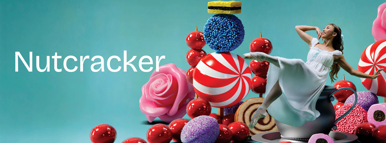 Ballerina dancing among oversized sweets for Nutcracker West End show.