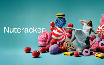 Ballerina dancing among oversized sweets for Nutcracker West End show.