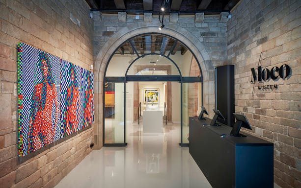 Moco Museum entrance with colorful artwork in Barcelona, Spain.