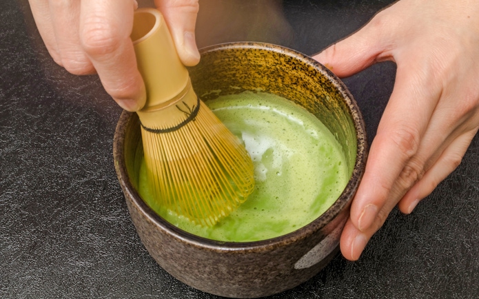 Matcha being whisked in a bowl during a tea ceremony in Tokyo.