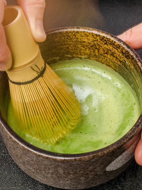 Matcha being whisked in a bowl during a tea ceremony in Tokyo.