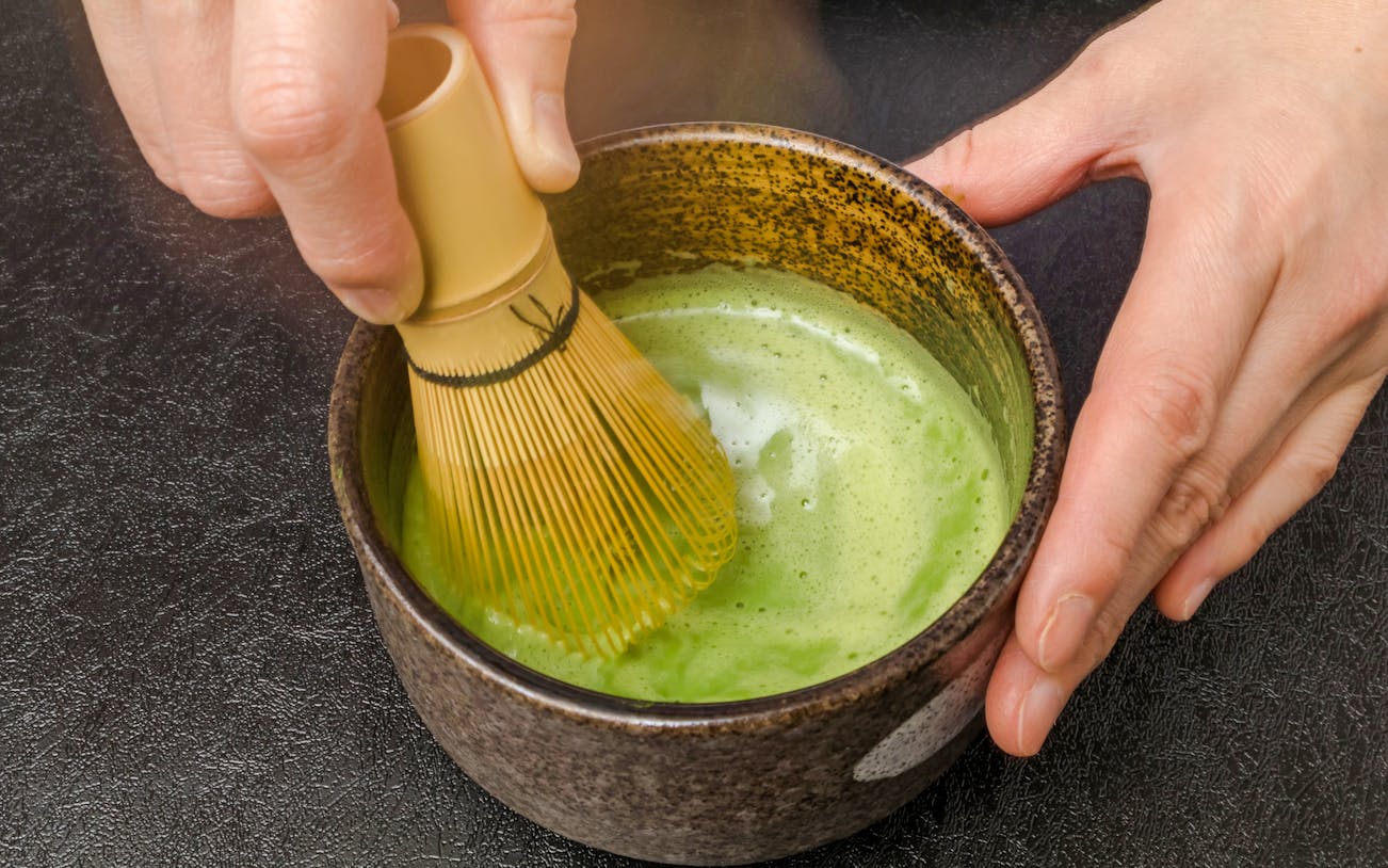 Matcha being whisked in a bowl during a tea ceremony in Tokyo.