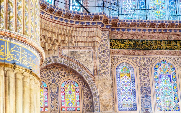 Intricate interior tilework and stained glass windows of the Blue Mosque, Istanbul.