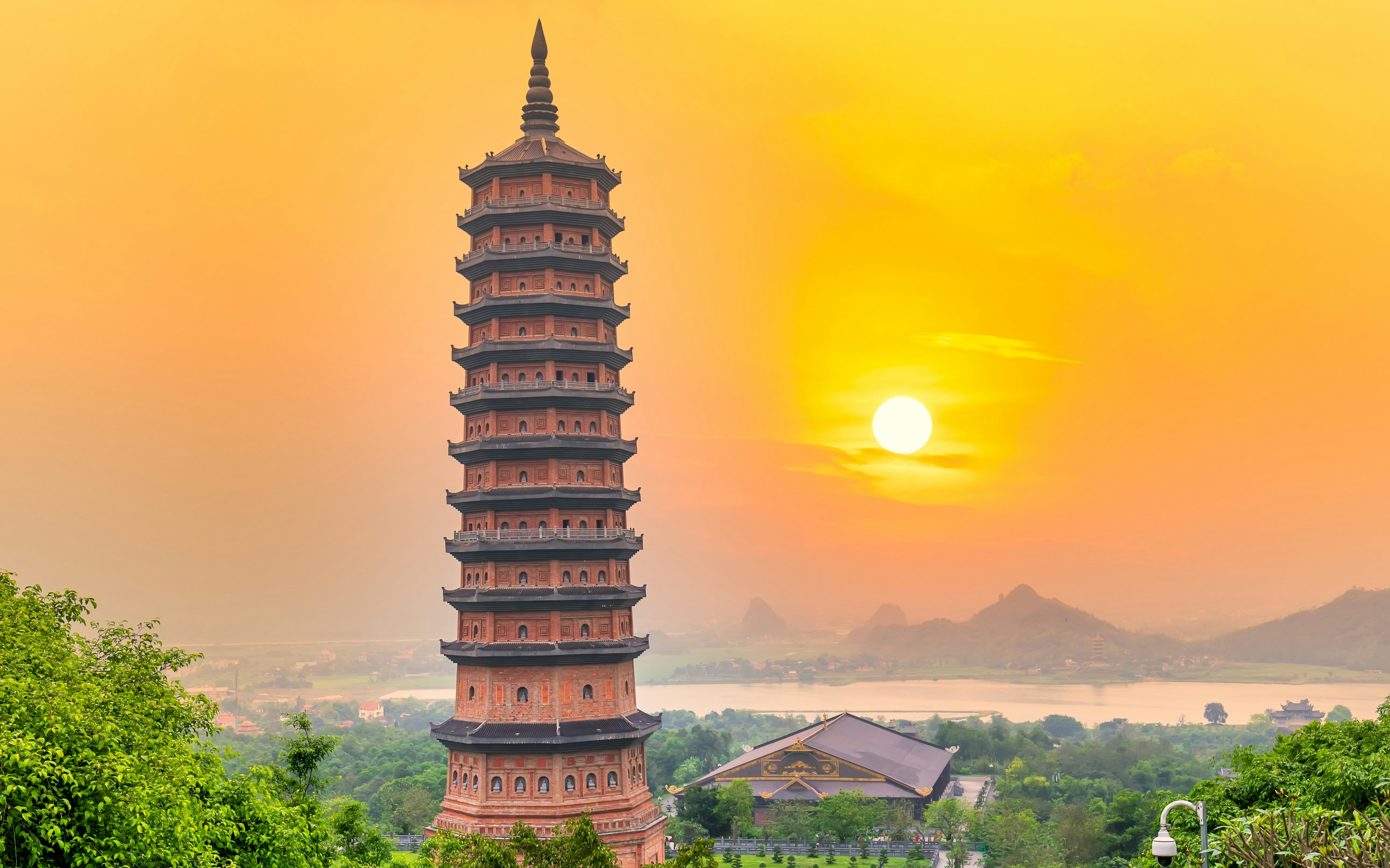Bai Dinh temple pagoda at sunset with mountains in the background, Vietnam.