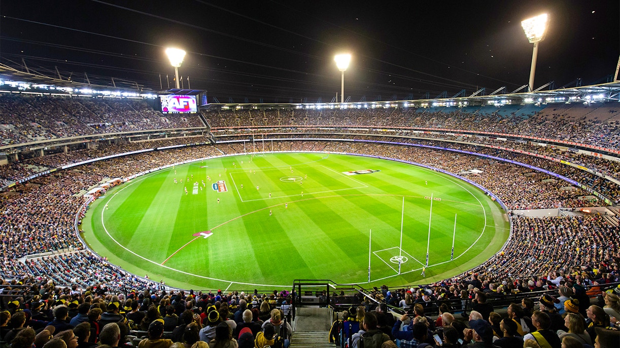 Melbourne Cricket Ground exterior with guided tour group.