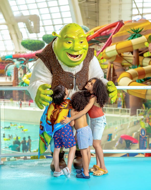 Kids hugging a character at Forbidden Waters Pool, American Dream DreamWorks Water Park.