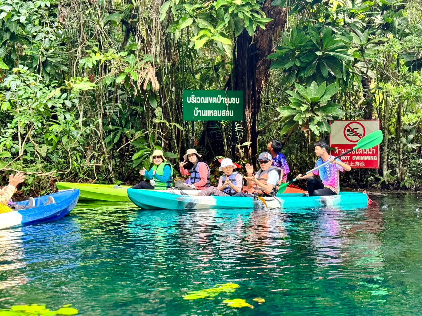 Kayakers paddling through lush greenery in Krabi, Thailand.