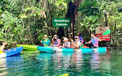 Kayakers paddling through lush greenery in Krabi, Thailand.