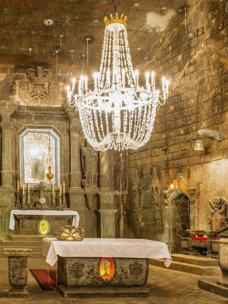 Chapel in Wieliczka Salt Mine with ornate altar and chandelier.