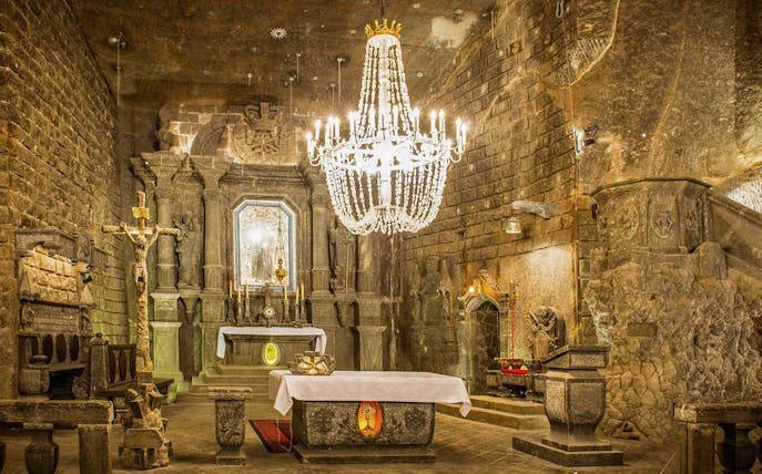 Chapel in Wieliczka Salt Mine with ornate altar and chandelier.