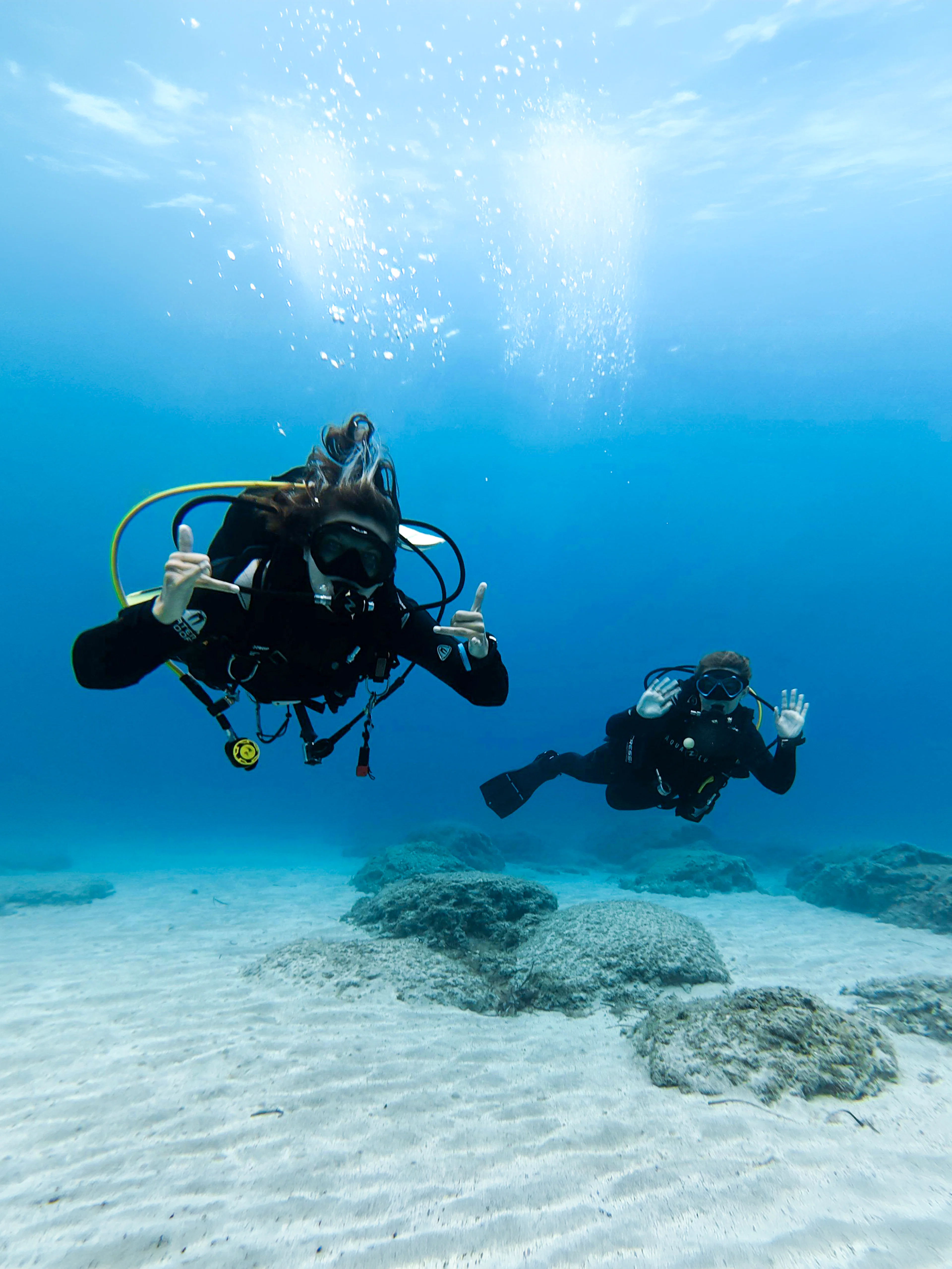 Divers exploring underwater in Green Bay during a private discovery dive.