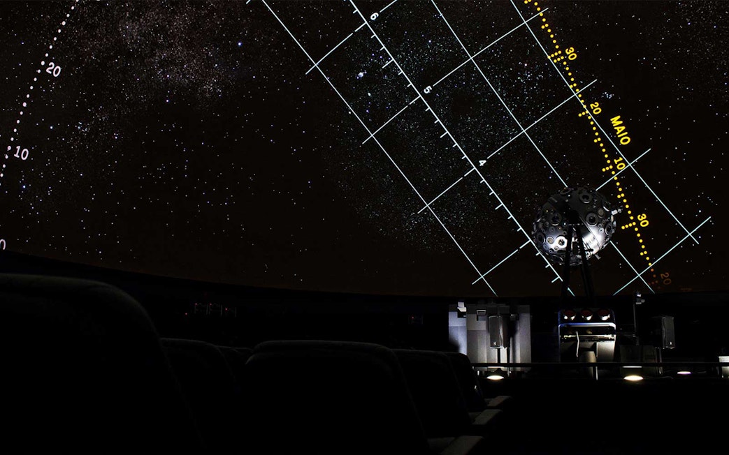 Planetarium dome with starry sky and projection equipment in Lisbon.