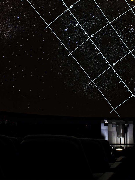 Planetarium dome with starry sky and projection equipment in Lisbon.