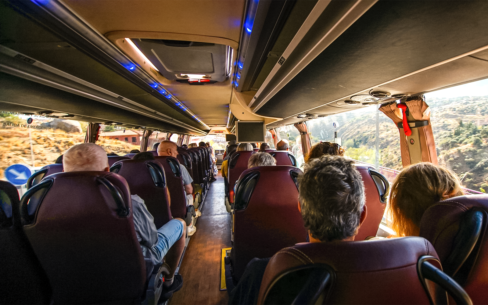 Passengers seated on a bus traveling from Madrid to Toledo.