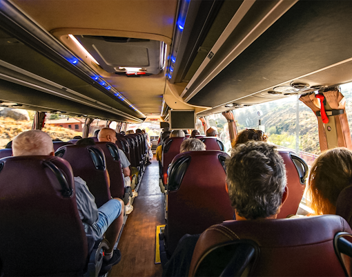 Passengers seated on a bus traveling from Madrid to Toledo.