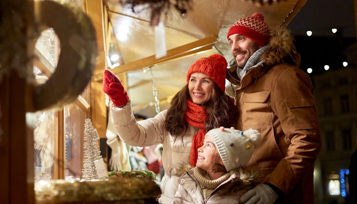 Family exploring Christmas market on Big Bus New York Holiday Lights Tour.