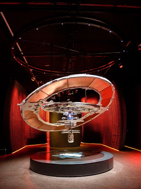 Futuristic exhibit in red-lit room at Museum of The Future, Dubai.