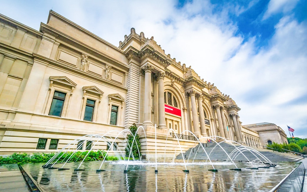 The Met Museum entrance with fountain and steps, New York City.