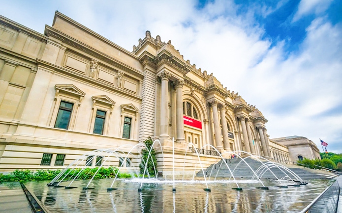 The Met Museum entrance with fountain and steps, New York City.