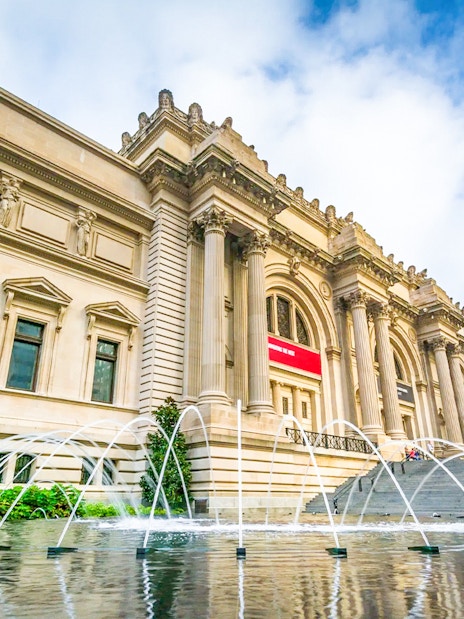 The Met Museum entrance with fountain and steps, New York City.
