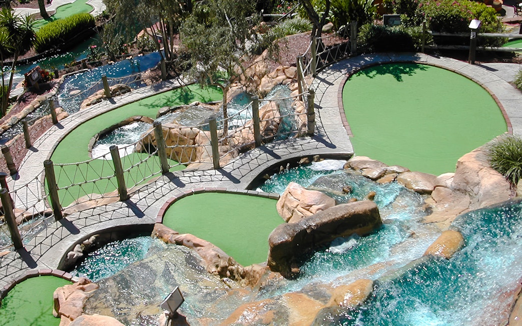 Mini-golf course with waterfalls and bridges at Pirate's Cove Adventure Golf.