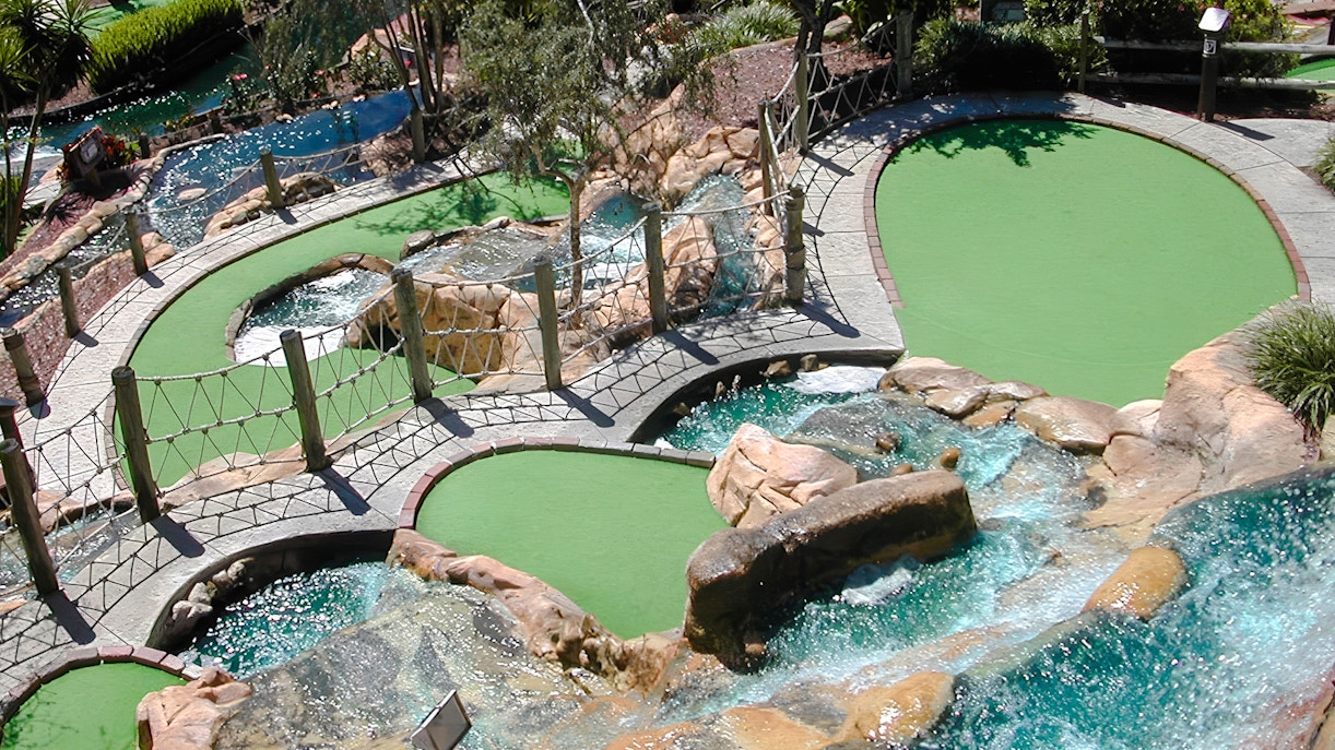 Mini-golf course with waterfalls and bridges at Pirate's Cove Adventure Golf.