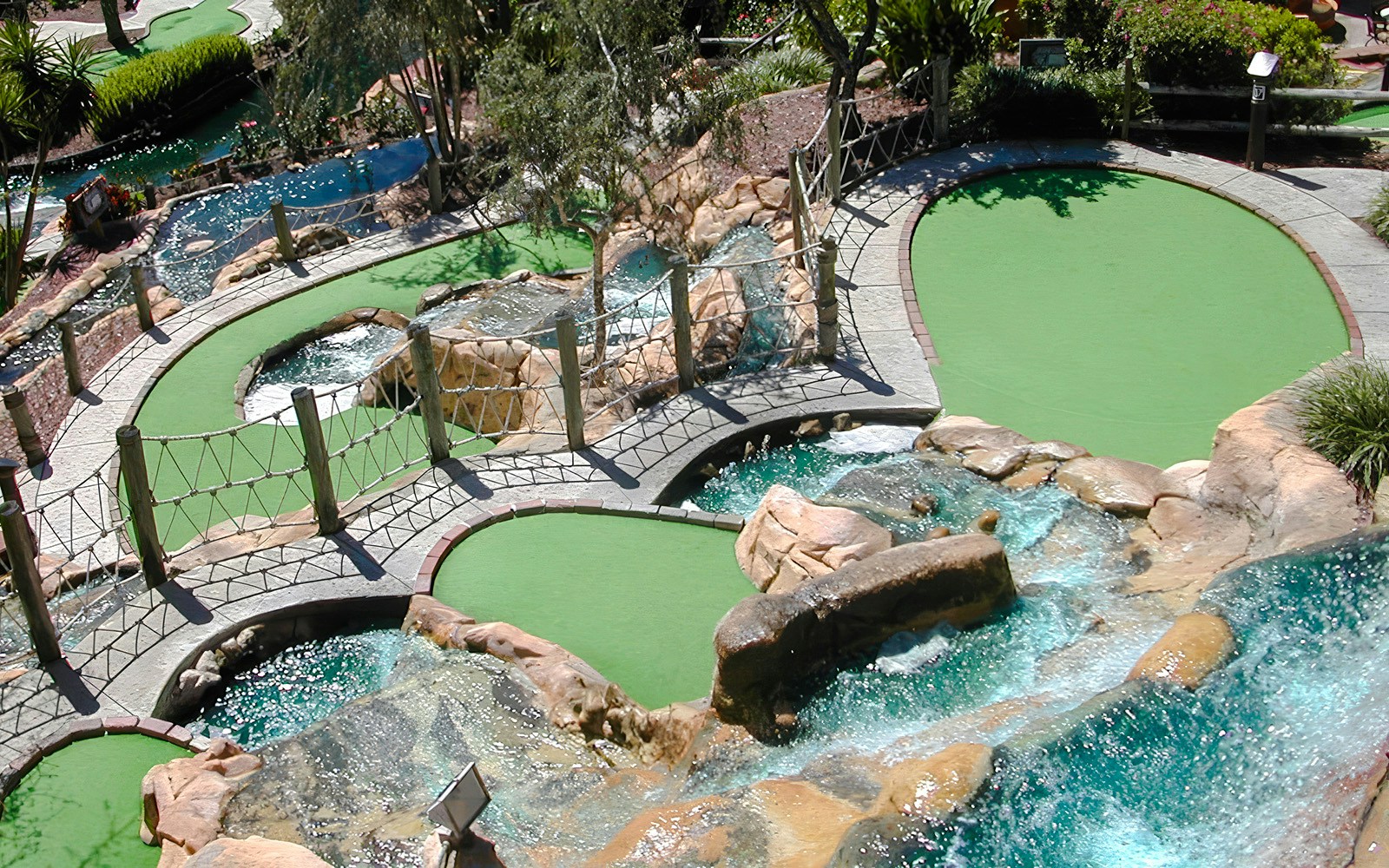 Mini-golf course with waterfalls and bridges at Pirate's Cove Adventure Golf.