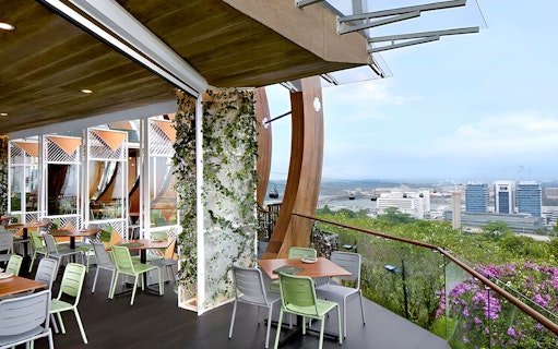 Dining area with view of Sentosa skyline and cable cars from Mount Faber.