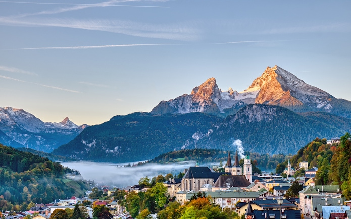 Salzburg cityscape with mountains and mist, seen on a guided tour to St. Wolfgang and Salzkammergut.