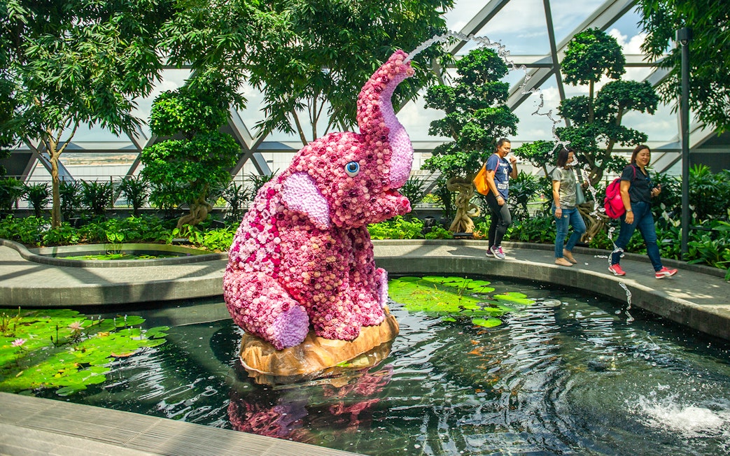 Topiary elephant sculpture in pond at Topiary Walk, Jewel Changi, Singapore.