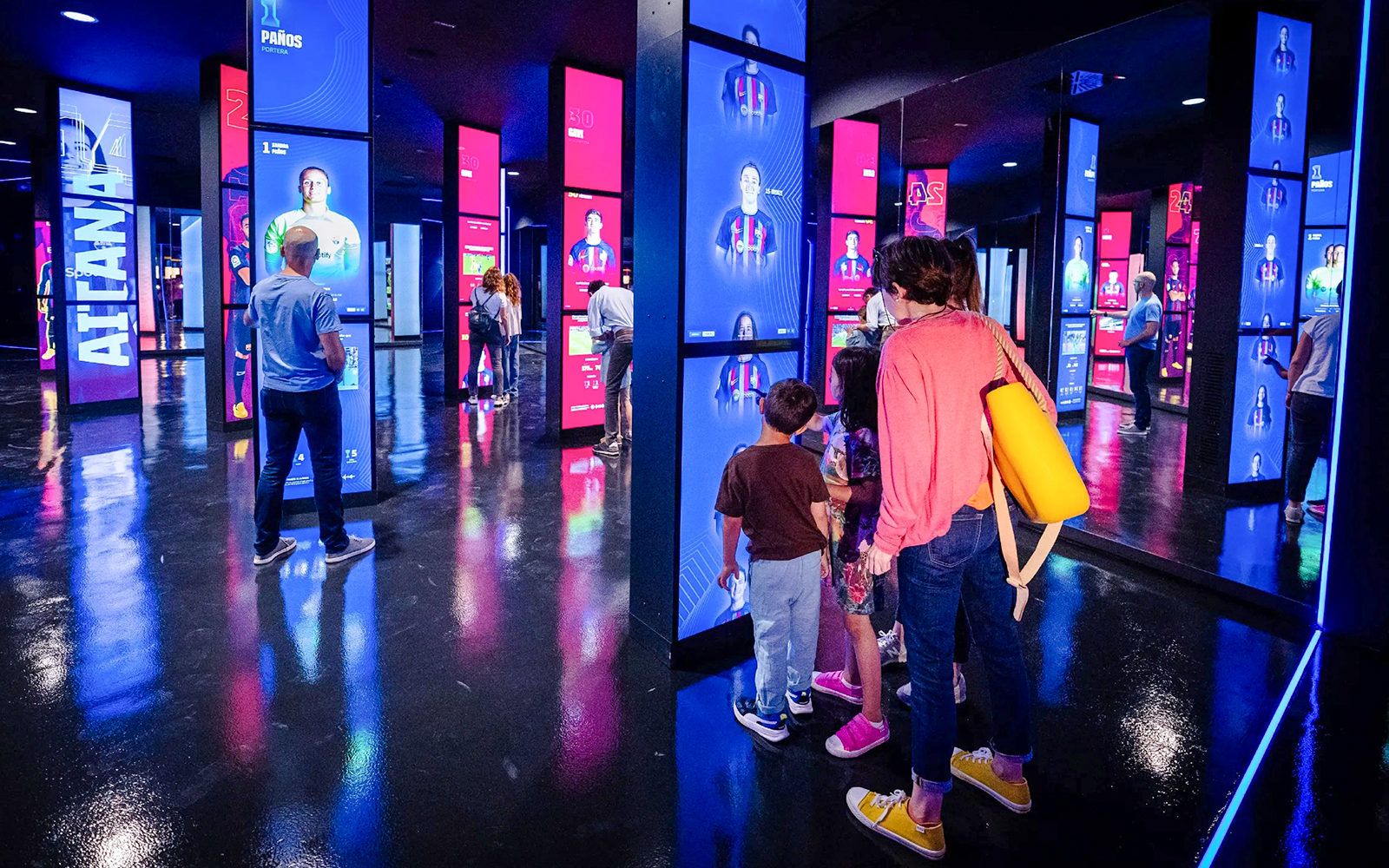 Visitors exploring interactive displays at the Spotify Camp Nou Barça Museum.