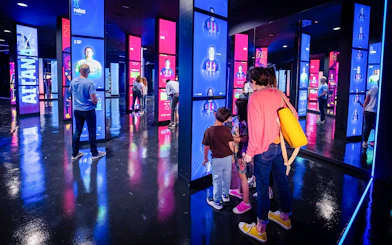 Visitors exploring interactive displays at the Spotify Camp Nou Barça Museum.