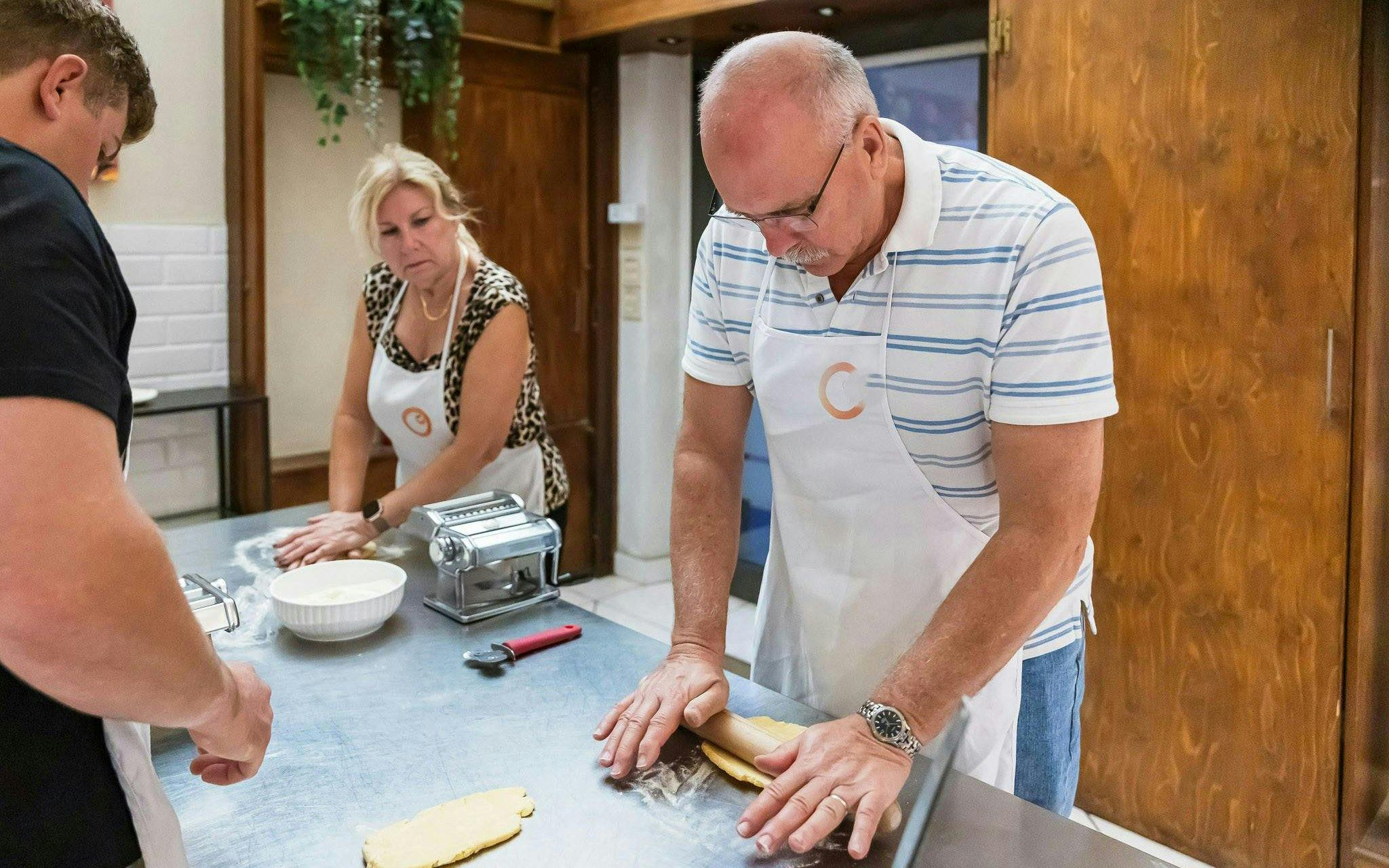 Small group making pasta in a cooking class in Florence.
