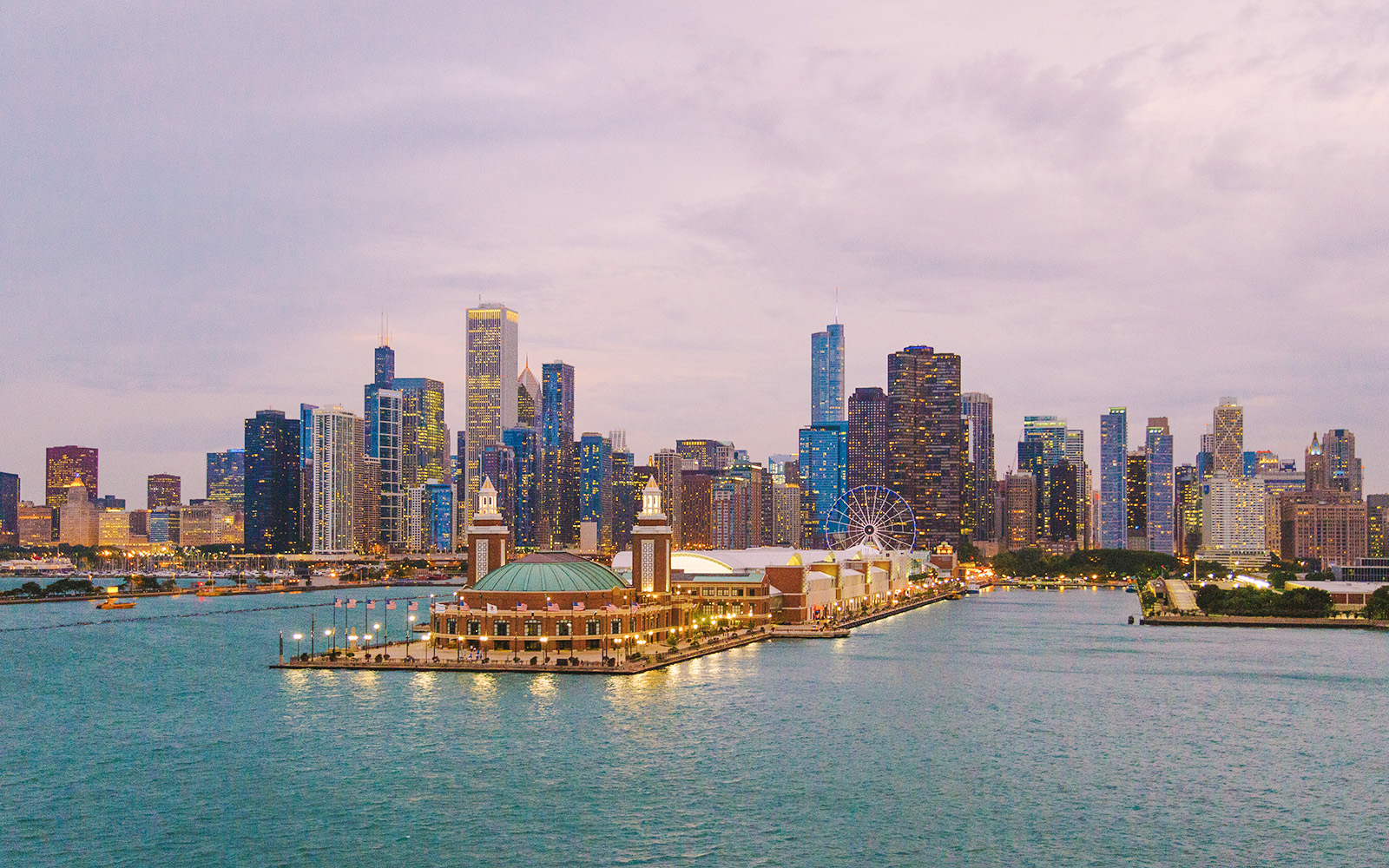Chicago skyline with Navy Pier and Ferris wheel at sunset.