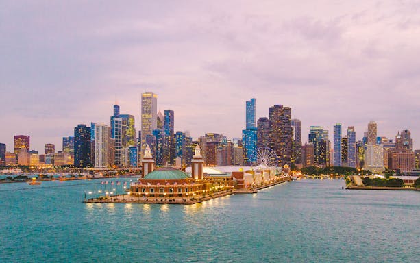 Chicago skyline with Navy Pier and Ferris wheel at sunset.