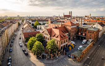 Aerial view of Munich brewery near Oktoberfest site, highlighting traditional architecture.