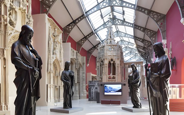 Sculptures displayed at Notre-Dame de Paris Exhibition in a gallery setting.