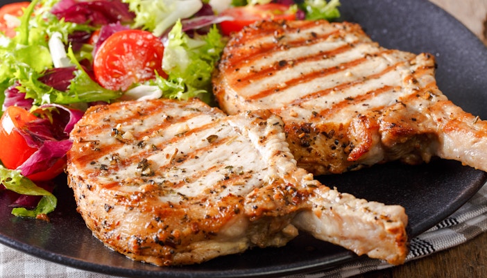 Grilled pork chops with salad at Delphi Restaurant.