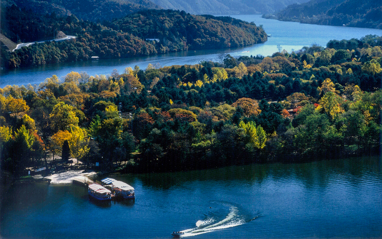 Scenic view of a waterbody and forested mountains in Nami Island, South Korea.